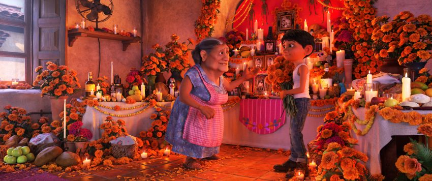 COCO - In Disney•Pixar’s “Coco,” Abuelita (voice of Renée Victor) and Miguel (voice of Anthony Gonzalez) ensure that their home is adorned for Día de Muertos, including an elaborate ofrenda that holds several framed family pictures, flowers, candles, favorite foods and—because they are in the shoemaking business—shoes. “Coco” opens in n U.S. theaters on Nov. 22, 2017. ©2017 Disney•Pixar. All Rights Reserved.